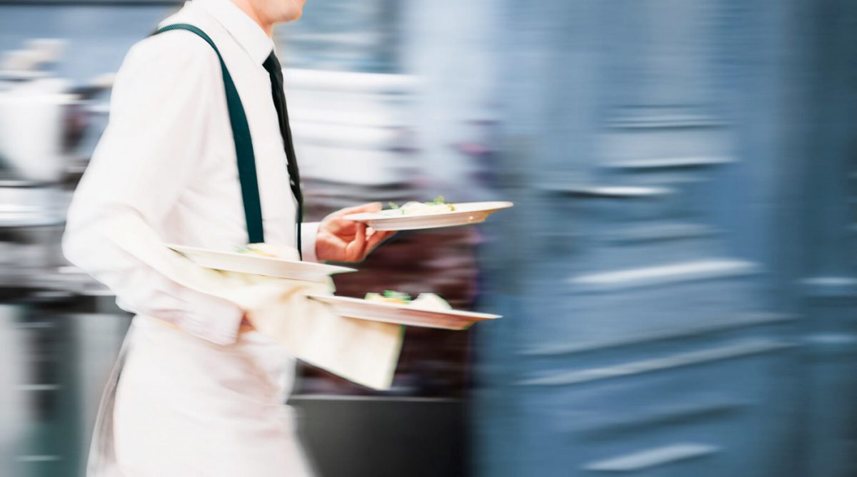 restaurant employee holding food