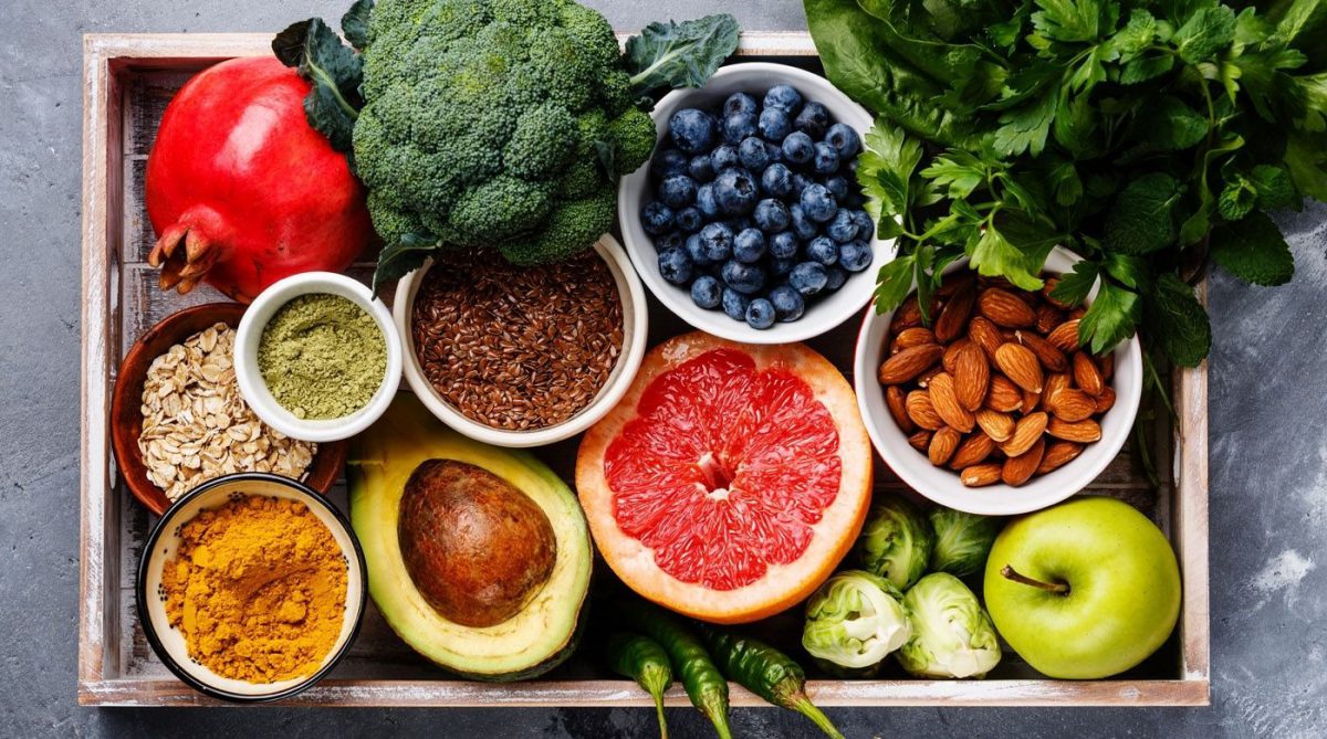 Tray filled with several nuts, vegetables and fruits.