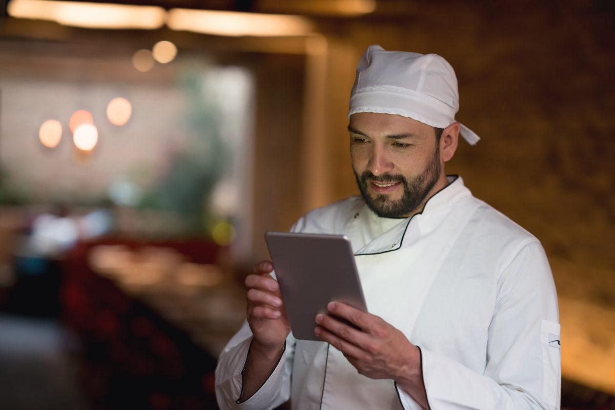Chef using handheld tablet