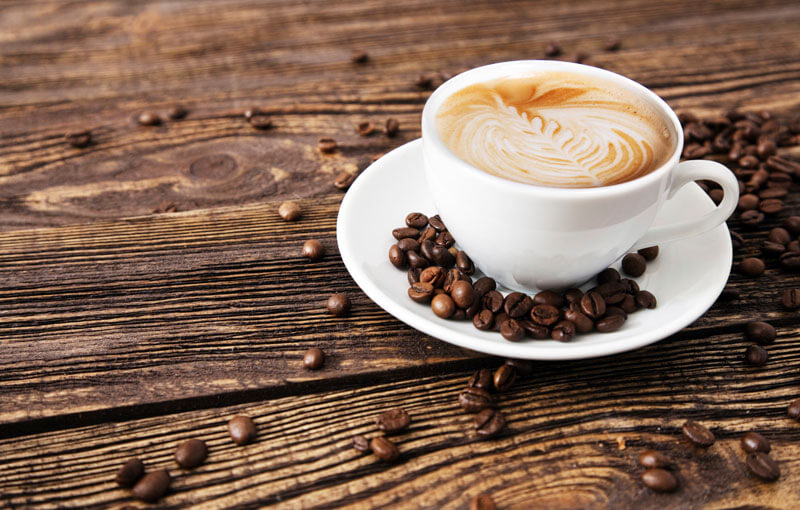 Coffee sitting on wooden table