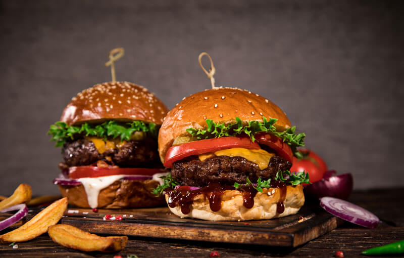 Juicy layered burgers dripping with sauce