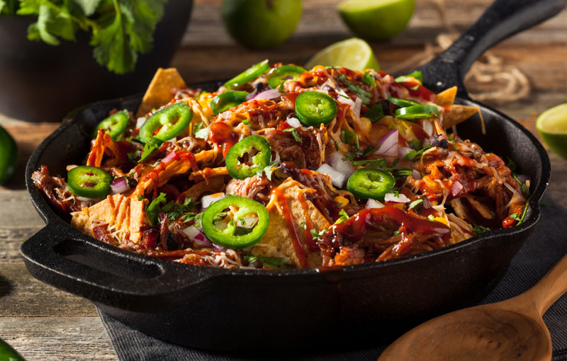 Layered nachos in an iron skillet