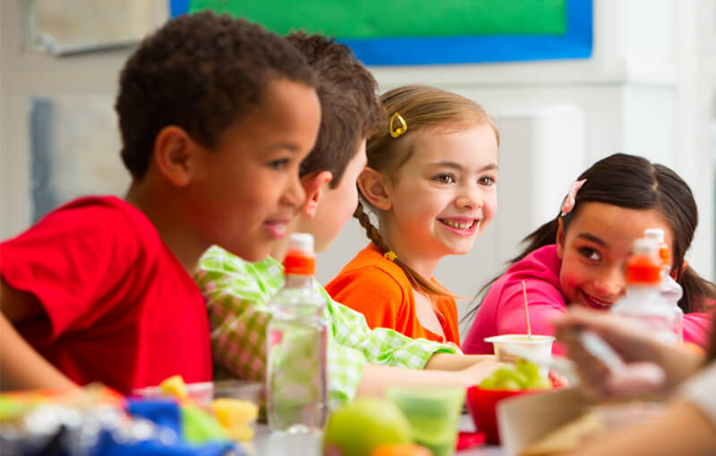 Kids eating at lunch table