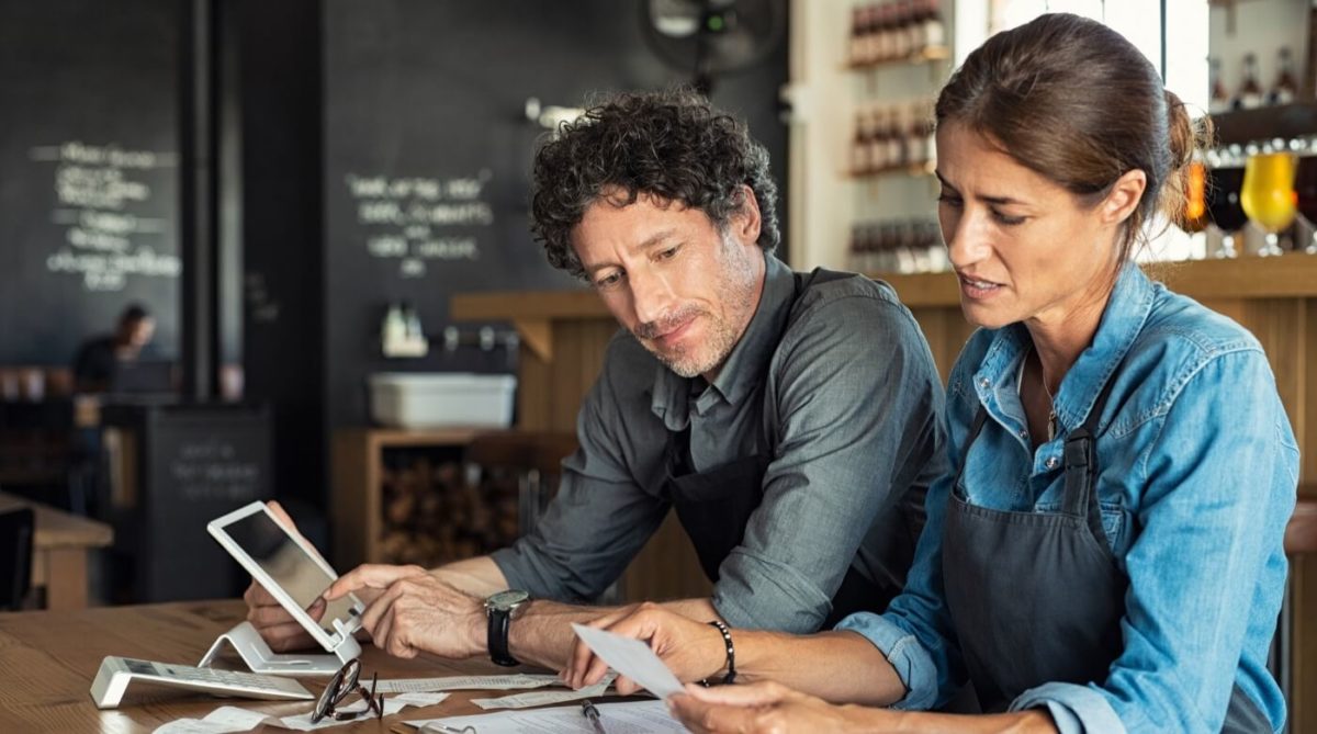 man and women looking at reciepts