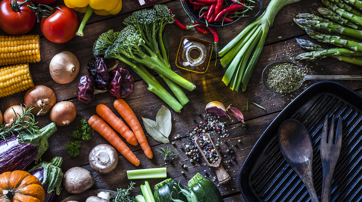 Fresh vegetables ready for cooking shot on rustic wooden table