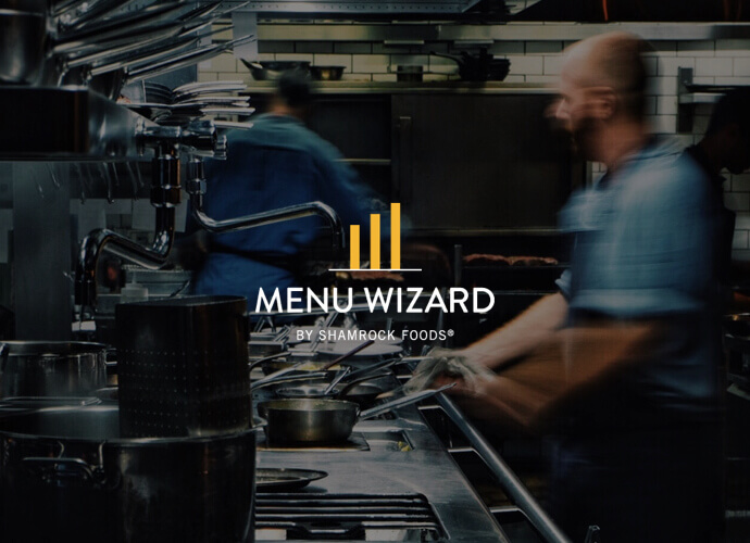 Men working in busy kitchen behind Menu Wizard logo