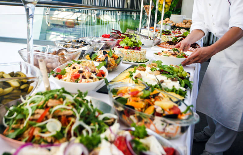 Buffet-style assortment of food on white table