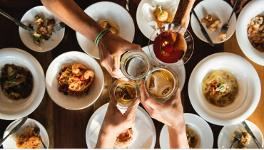 People toasting over a dining table