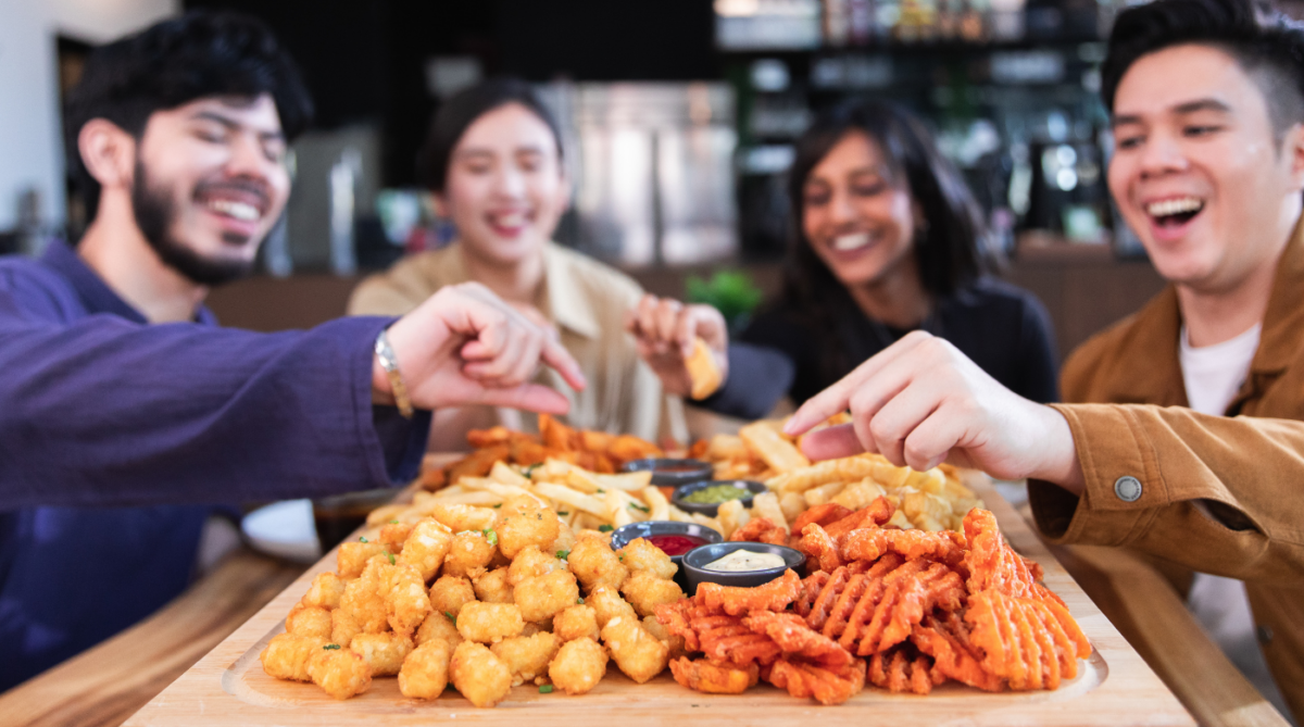 Friends sharing a restaurant fry board
