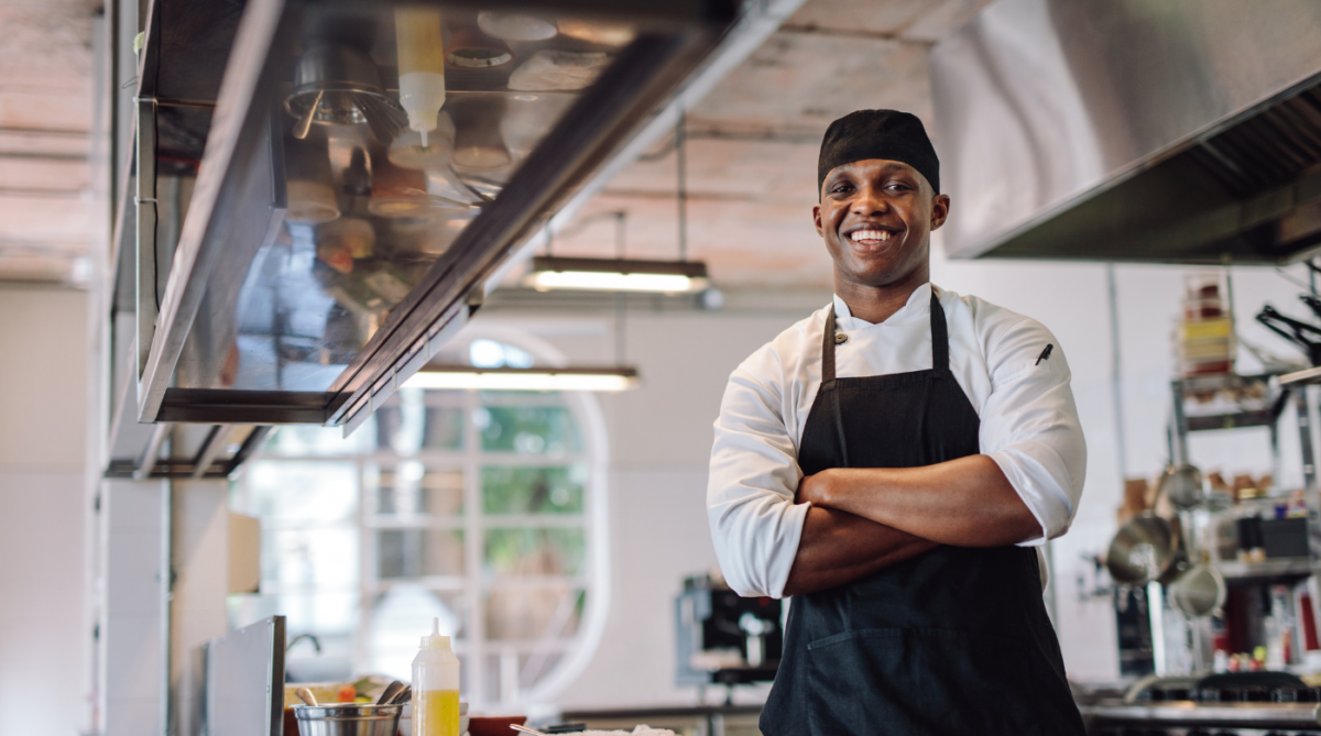 Chef in kitchen smiling