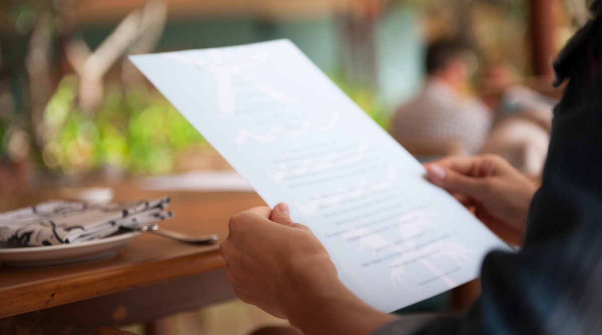 customer patron holding menu at a restaurant